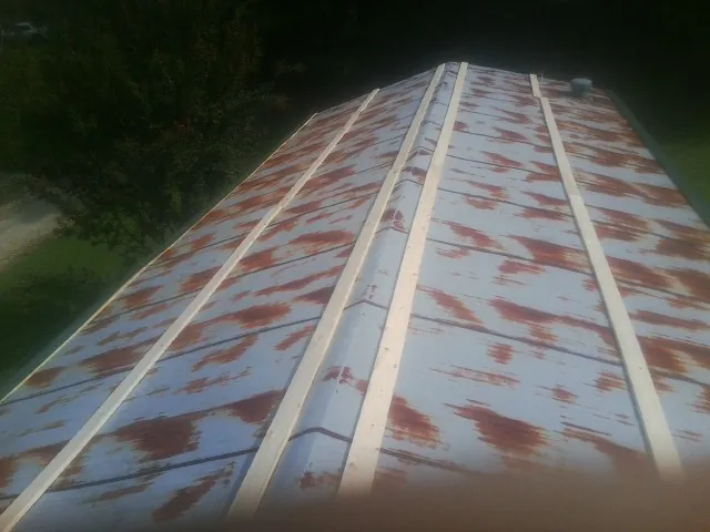 Rusted metal roof panels with new wood purlins before replacement — Storm Damage Roof Repair in El Sobrante by Roofing Brothers