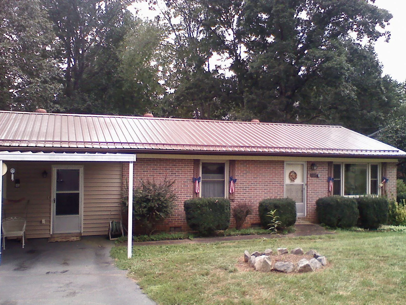 Bronze metal roof and carport on a brick ranch home — Roof Repair work by our crew in El Sobrante