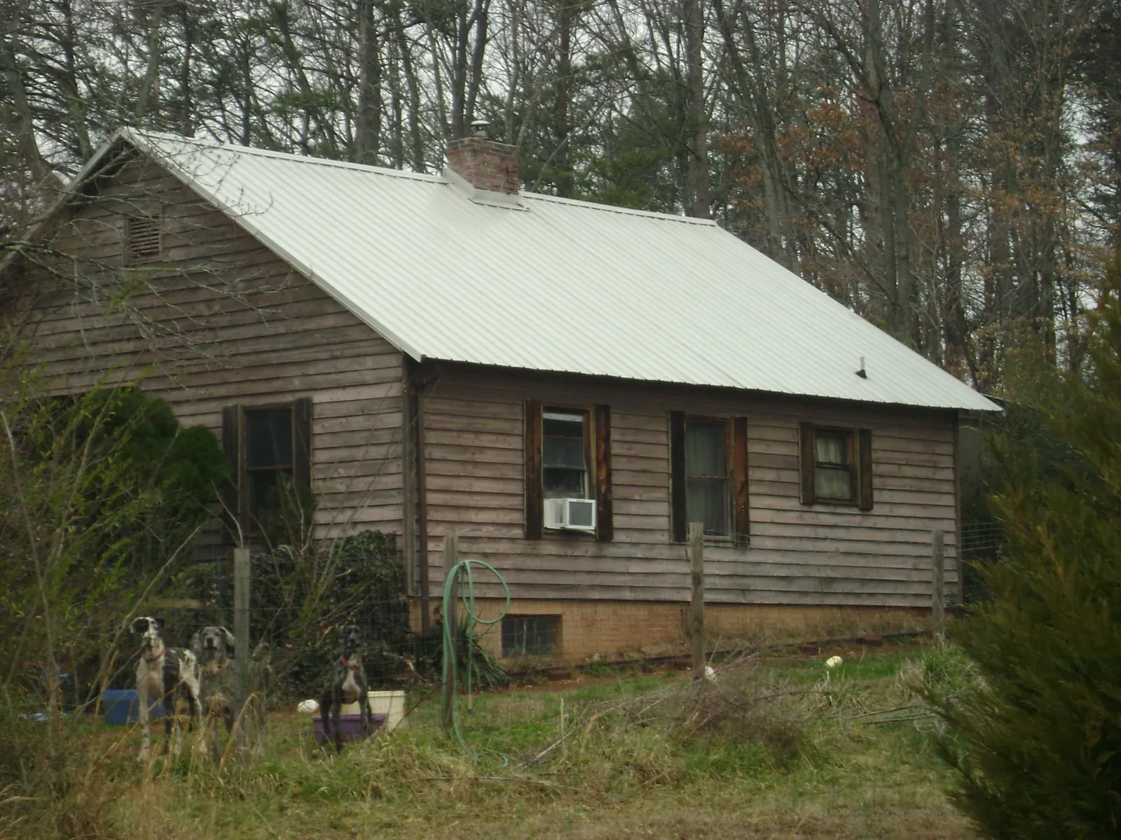 White metal roof on an old wood sided farmhouse, from a Metal Roof Installation job in El Sobrante